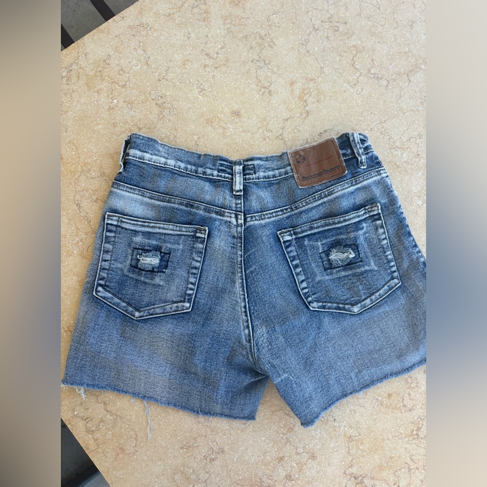 Blue denim shorts with frayed hem